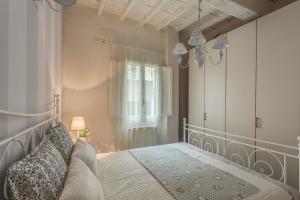 a bedroom with a bed and a window at Apartments Florence- Santa Maria Novella in Florence