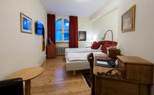 a living room with a couch and a table at Frimurarehotellet; Sure Hotel Collection by Best Western in Kalmar +36 photos