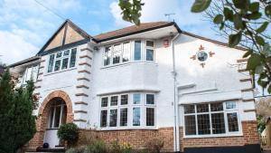 a white house with a red brick at The Wing -Near to the beaches and Bournemouth University in Bournemouth