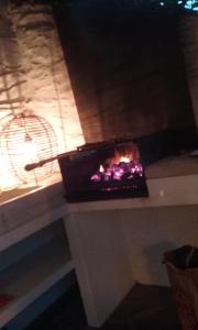 a fireplace sitting on a table with a fan at Casa Margot in Cadaqués