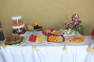 a table topped with lots of different types of food at Praia Da Oura - Boutique Resort in Majorda