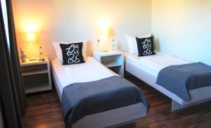 Postel nebo postele na pokoji v ubytování Sonata City Hotel