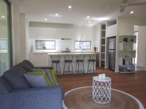a living room with a couch and a kitchen at Stay @ LP Montville in Montville