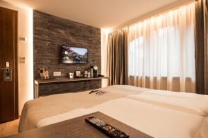 Vuode tai vuoteita majoituspaikassa Hotel Daniela