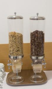 two glass containers filled with different types of nuts at Troia Hotel in Amares