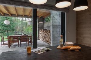a dining room with a table and a fireplace at ArtHouse Pelnik in Łukta