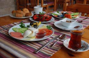 a table with plates of food on a table at Rain Hotel in Kizkalesi