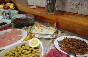 a table topped with plates of food on a table at Rain Hotel in Kizkalesi