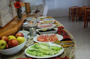 a table with many plates of food on it at Rain Hotel in Kizkalesi