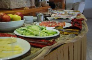 a buffet with plates of food on a table at Rain Hotel in Kizkalesi