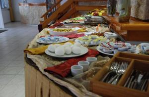 a buffet with plates of food on a table at Rain Hotel in Kizkalesi