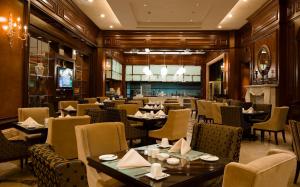 a restaurant with tables and chairs and a bar at Grand Concordia Hotel in Beijing