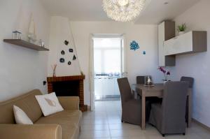 a living room with a couch and a dining room table at case per vacanze torre incina in Polignano a Mare