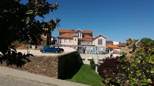 a blue car parked in front of a large house at Palacio Nova Seara 2503 - AL in Armamar