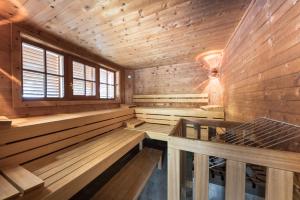 a wooden sauna with benches and a window at Hotel Krimmlerfälle in Krimml