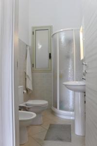 a bathroom with a toilet and a sink and a shower at Casa Le Pigne in Avola +56 photos