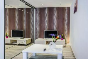 a living room with a white table and two monitors at Alpha loft 1BR apartment in center in Zadar