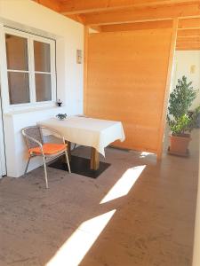 a white table and a chair in a patio at Brandlgut in Bolzano