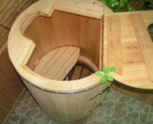 a small wooden sauna with a wooden seat in it at Villa Rupcovoto in Smolyan