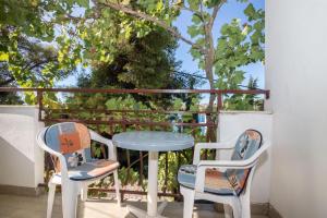 two chairs and a table on a balcony at Apartments Dane in Trogir