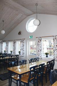 a dining room with tables and chairs and windows at Trosa Vandrarhem in Trosa