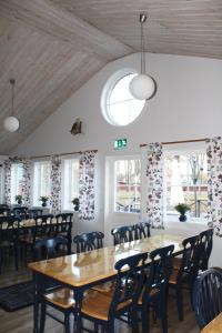 a dining room with tables and chairs and windows at Trosa Vandrarhem in Trosa +38 photos