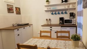 a kitchen with a table and chairs and a microwave at City Apartment, good location in Berlin