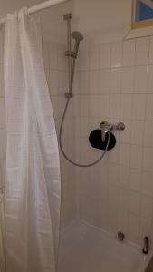 a shower with a shower curtain in a bathroom at City Apartment, good location in Berlin