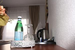 a bottle of wine sitting on top of a table at Hotel Vesa in Sindelfingen