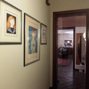 a hallway with three framed pictures on a wall at La Casa di Enrico in Caorle