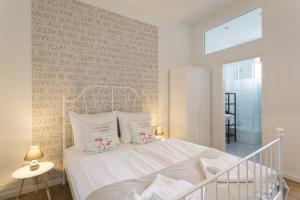 a bedroom with a white bed and a wall with writing at Stylish & Cosy Apartment in Berlin, WiFi in Berlin