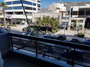 a balcony with a view of a street with cars at Central Apartment in Athens