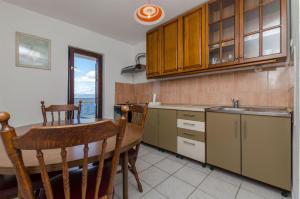 a kitchen with a table and a dining room at Apartment Barba in Rogač