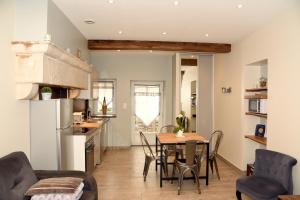 a kitchen and dining room with a table and chairs at Gite le murger in Meursault