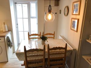 a dining room with a table and chairs and a window at North Walls cottage in Chichester