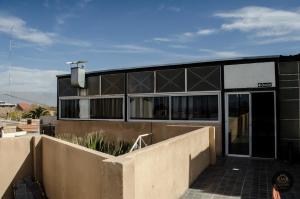 a building with black windows and a fence at Terraza del Sol Apart in San Juan