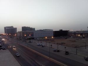 a city street with cars on a highway at dusk at Al Makan Al Mosafer 116 Hotel by Al Azmy in Riyadh