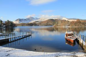 a boat is docked at a dock on a lake at West View in Keswick