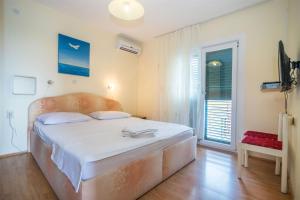 Postel nebo postele na pokoji v ubytování Apartments Rose