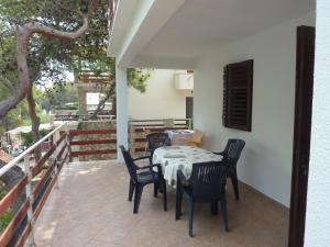 a patio with a table and chairs on a balcony at Apartments Antun in Vrboska