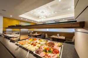 a buffet line with many different types of food at Hotel am Dom in Fulda