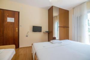 Postel nebo postele na pokoji v ubytování Apartments Rose
