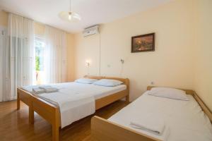 Postel nebo postele na pokoji v ubytování Apartments Rose