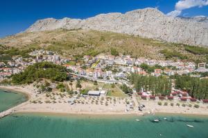 an aerial view of a beach in front of a mountain at Apartments Srecko in Duće