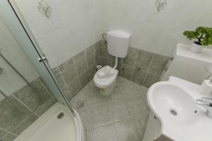 a bathroom with a toilet and a sink at Apartments Srecko in Duće +26 photos