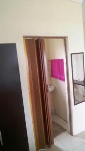 an open door to a bathroom with a toilet at Hillside View Guesthouse in Coffee Bay