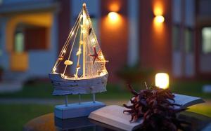 a toy boat sitting on top of a book at Residence Garden in Sellia Marina