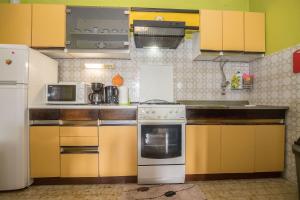 a kitchen with yellow cabinets and white appliances at Apartments Ante in Igrane