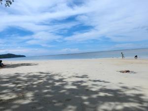 a group of people on a beach with a kite at One One Hostel Patong in Patong Beach
