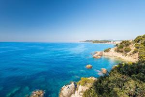 a view of the ocean with rocks in the water at htop Amatista #htopBliss in Lloret de Mar